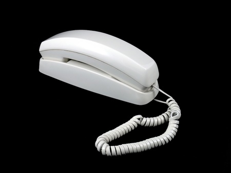 An old corded phone isolated on a black backgroundの写真素材