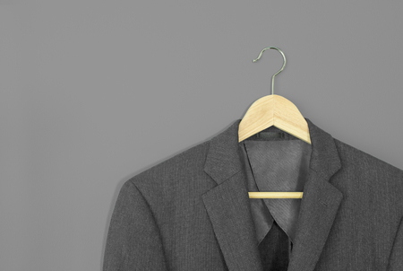 wood hanger with light grey suit isolated on grey backgroundの写真素材