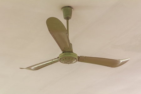 Dirty ceiling fan in a room の写真素材