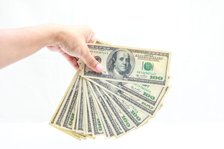 Hold one hundred dollars in hand on white background.