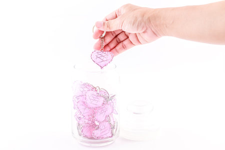 Hold heart wire pink put into bottle.