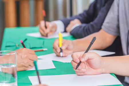 Businessmen hands is writing report about a meeting.の写真素材