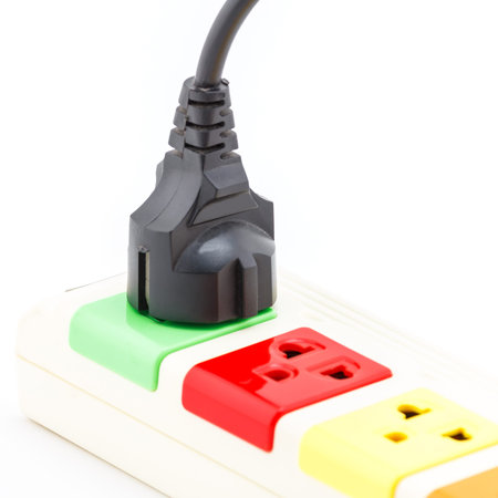 Beautiful plugs colorful plugged into electric power bar.