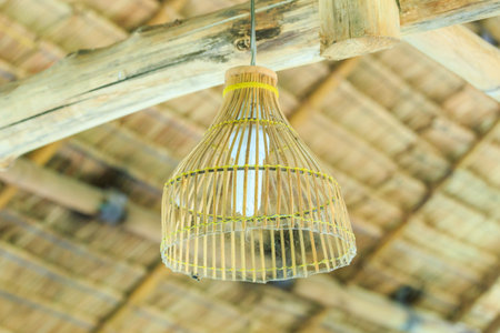 Beautiful wicker woven lantern on wood beam.の写真素材
