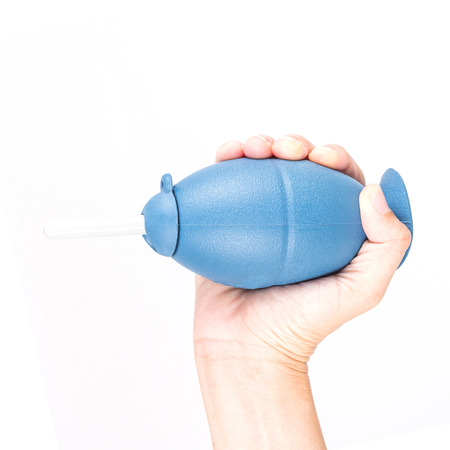 Hand holding air blower rubber isolated on white background.の写真素材