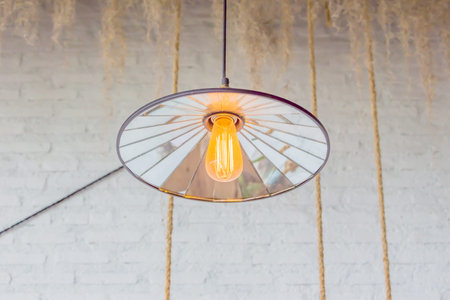 Old lamp hanging white brick wall background.
