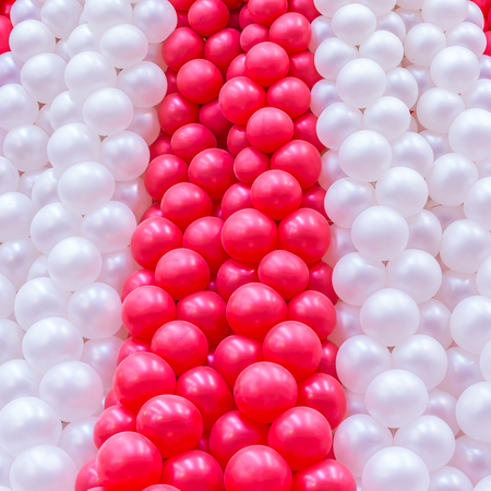 Red and white balloons many in row on background.の写真素材