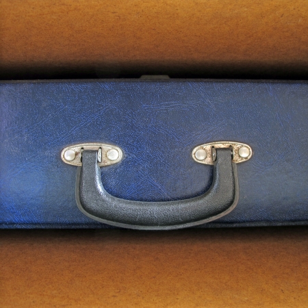 old blue briefcase in wooden shelfの写真素材