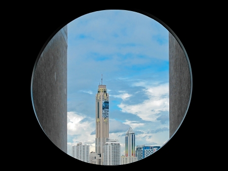BANGKOK - AUGUST 16  Bangkok s high building in circle window frame  High rise building in Bangkok increase every year and the height of building is used in marketing and advertisement on August 16, 2013 in Bangkok, Thailand のeditorial素材
