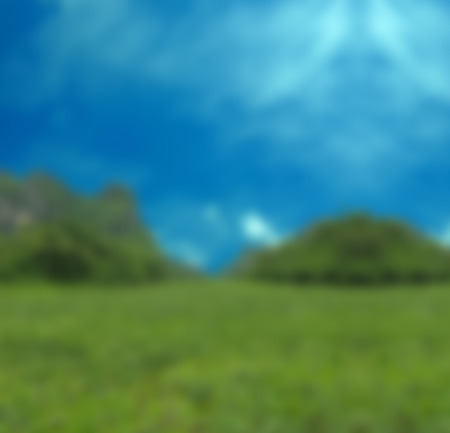 Blurred background of farmland with big mountain and blue sky.の写真素材