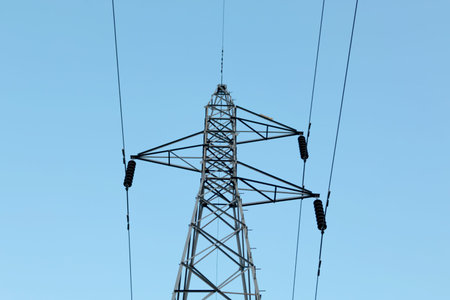 high voltage post with blue sky background.