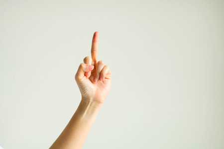 Hand sign showing middle finger in rude way meaning fuck off.の写真素材