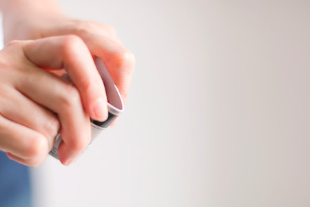 A person is breaking a credit card on white background, with copy space and soft focus.