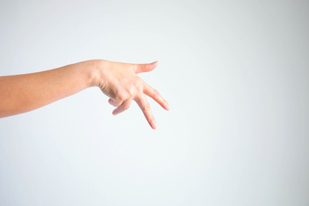 A hand showing thumb, forefinger and middle finger to look like shape of man walking; or like a hand of rapper; on white background with copy space.の写真素材