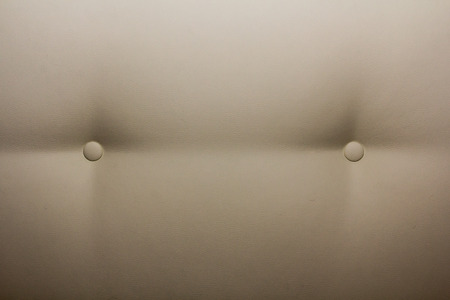 Light coloured leather sofa with two buttons textureの写真素材