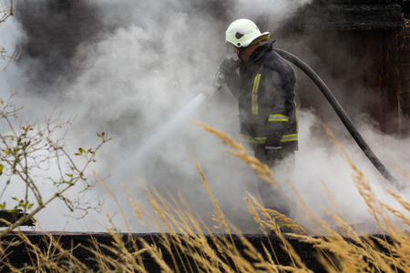 the work of firefighters in extinguishing the fire destroyed the village house 05.10.2018, in Mengele Latviaのeditorial素材