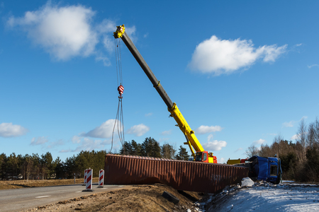 Car accident on a road in February 22, 2019 truck driver lost control over vehicle drove off the road and overturned, transportation backgroundの写真素材