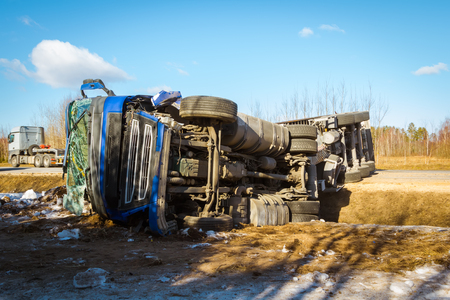 Car accident on a road in February 22, 2019 truck driver lost control over vehicle drove off the road and overturned, transportation backgroundの写真素材