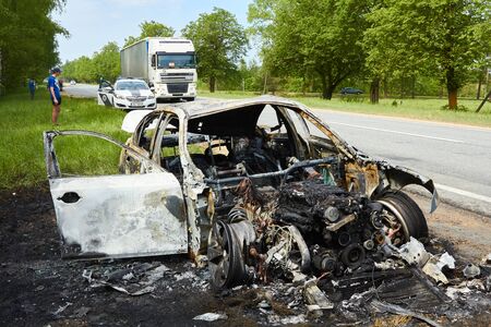 Fully burned car after collision with truck in summer in May 23, 2019, in Latvia, next to Pinki, accident backgroundのeditorial素材