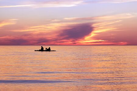 SUP boarding tour of the Gulf of Riga in the summer at sunset next to Tuya at rocky seashore of Vidzeme, Latviaの写真素材