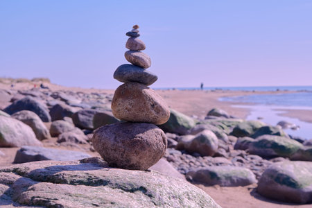 Zen balance of stones at rocky seashore of Baltic sea on sunny day