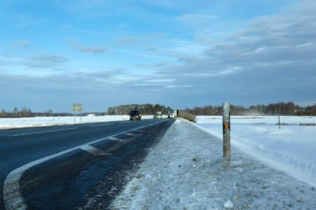 January 14, 2021, Iecava, Latvia: snow-covered road post near the highway, against the background of an accidentのeditorial素材