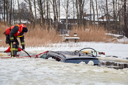 January 21, 2021, Baltezers, Latvia: The work of the rescue service to retrieve the car from the water. The car broke into the iceのeditorial素材