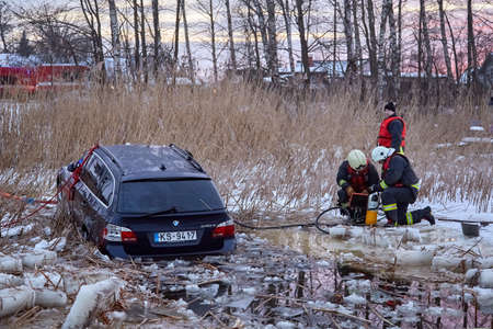 January 21, 2021, Baltezers, Latvia: The work of the rescue service to retrieve the car from the water. The car broke into the iceのeditorial素材