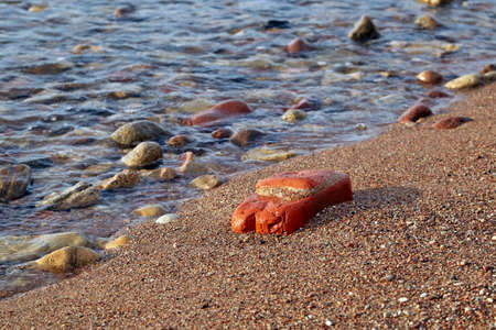 Stones at Baltic sea shore in Liepaja, Latvia in evening lightの写真素材