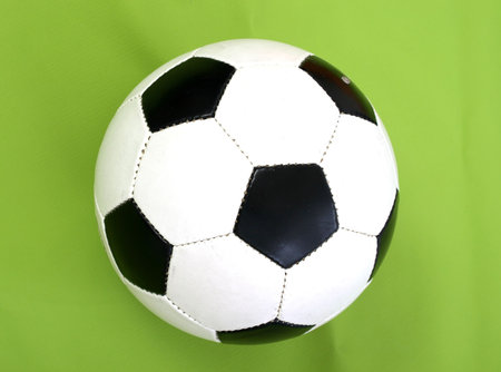 A typical soccer ball isolated on green 