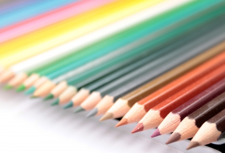 Colered wooden crayons over whiteの写真素材