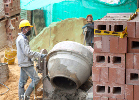 A house builder (bricklayer) at work.