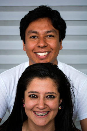 Smiling young couple in sofa at home.
