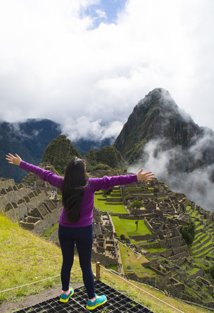 Success woman at sunset or sunrise in Machu Picchu.の写真素材