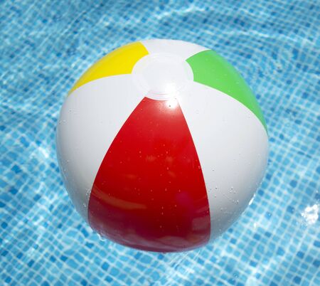 Beach ball floating in swimming pool abstract concept for summer vacations.の写真素材