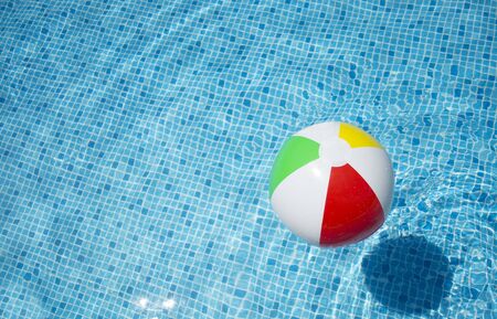Beach ball floating in swimming pool abstract concept for summer vacations.の写真素材