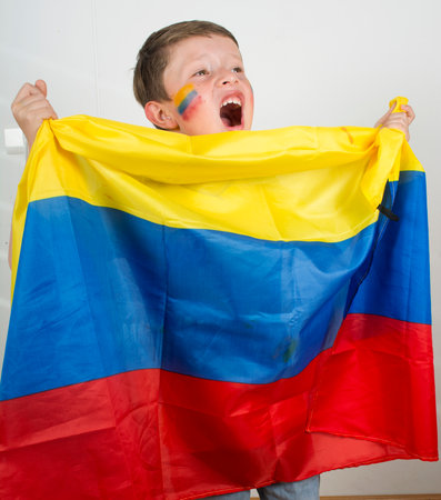 Happy young boy holding an Colombian flag.の写真素材