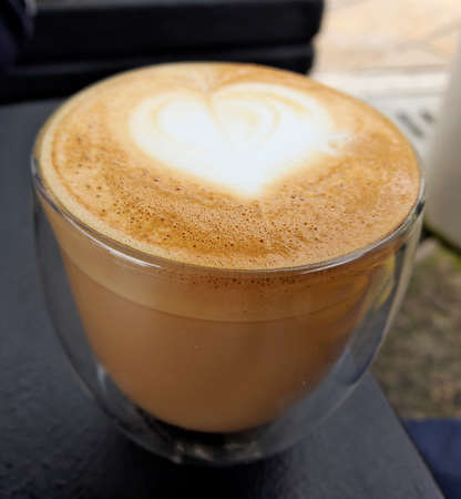Cup of coffee latte with heart shape and coffee colombian.の写真素材
