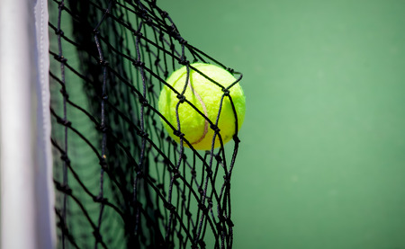 Tennis ball in netの写真素材