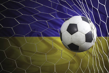 Ukraine flag and soccer ball, football in goal netの写真素材