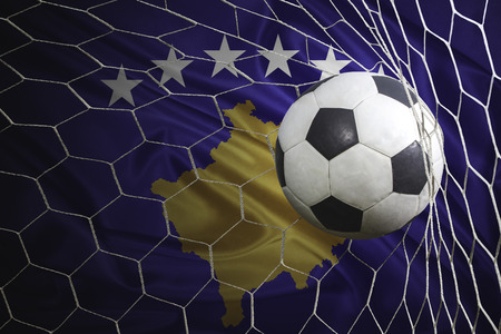 Kosovo flag and soccer ball, football in goal netの写真素材