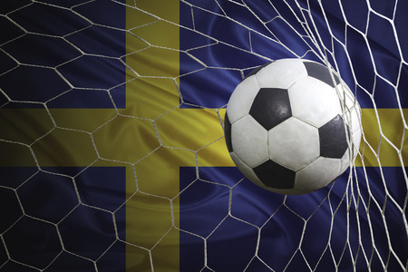Sweden flag and soccer ball, football in goal netの写真素材
