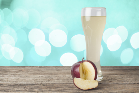 apple juice on the wooden table,bokeh backgroundの写真素材