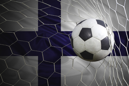 Finland flag and soccer ball, football in goal netの写真素材