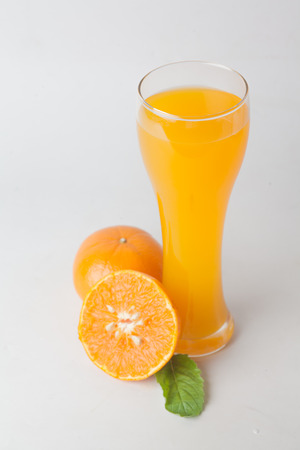 Orange juice and slices of orange isolated on whiteの写真素材
