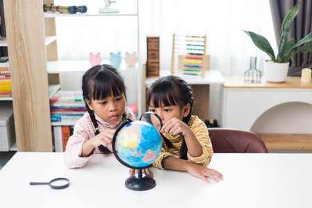 two sibling Asian studying geography at home.の写真素材