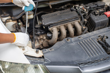 A person is working on a car engine