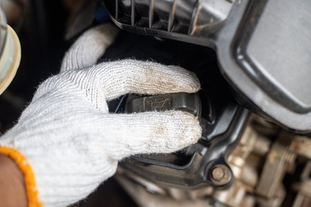 A person is working on a car engine