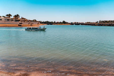 A ship with people driving in a lagoon El Gouna, Red Sea, Egyptの写真素材