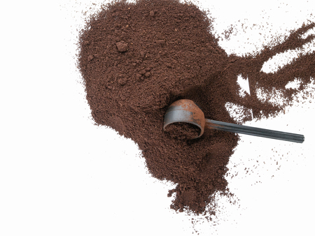 Isolated top view of spilled coffee grounds with scoopの写真素材